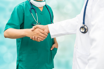 Doctors shaking hands. Medical people teamwork.