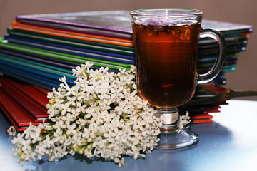 Lilac and flower tea in a glass cup

