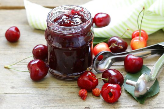 Organic cherry jam with fresh berries on the table