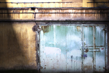 metal gate covered with shabby paint, grunge background