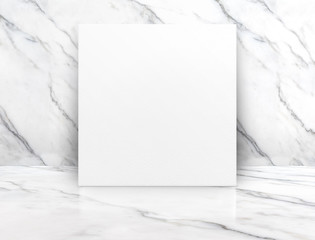 Blank white poster canvas in white glossy marble floor leaning at wall,Mock up template for display...