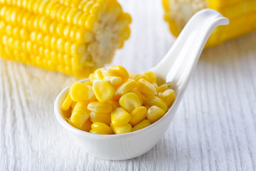 corn in a white bowl on wood table