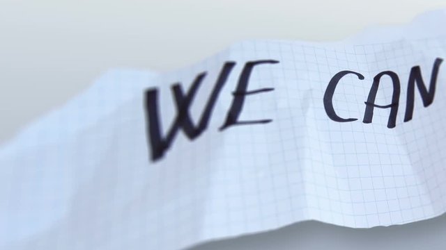 word" we can "  on torned paper  on gradient background.