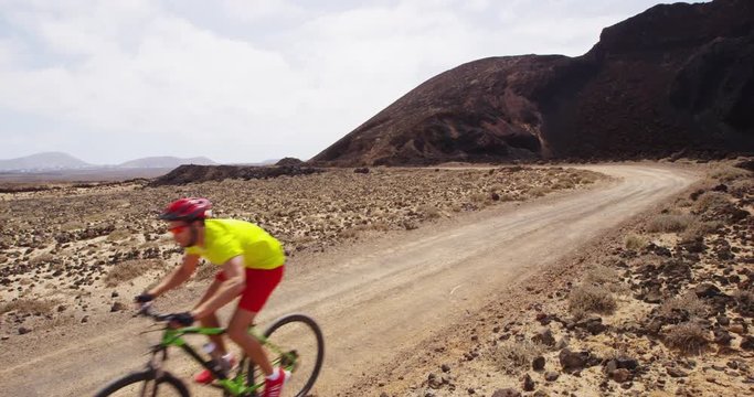 Mountain bike - man biking on MTB cycling trail. Man cycling enjoying healthy lifestyle and outdoor sports activity. Lanzarote, Canary Islands, Spain. RED EPIC SLOW MOTION.