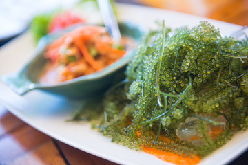 Thai spicy papaya salad with seaweed caviar or sea grape