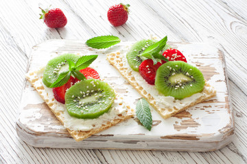 Waffles with soft chese, strawberries and kiwi