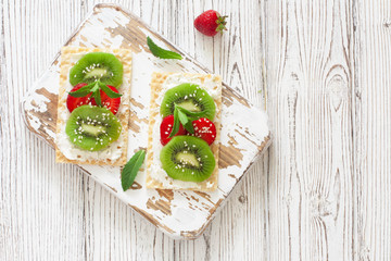 Waffles with soft chese, strawberries and kiwi