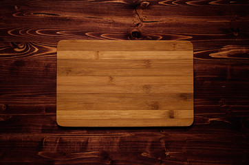 Bamboo blank sign board on brown vintage wood plank, top view. Mock up for company identity,...