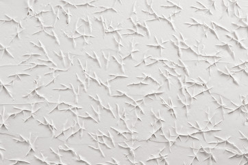 Fototapeta premium White decorative abstract plaster texture with cracks, splash, footprints.