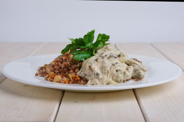 Beef stroganoff with creamy onion sauce and buckwheat with fried mushrooms
