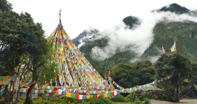 4k prayer flag with snow mountain in tibet.