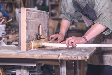 a man working with wood product on the machine