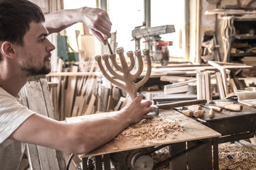 male carpenter working with a wood product, hand tools