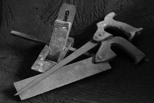 A set of traditional old vintage woodworking tools in black and white image