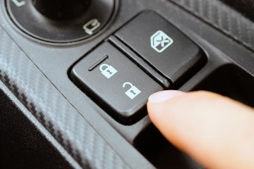 image of hand push the car lock button.