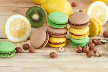 Green, yellow and brown french macarons with lemon, kiwi and hazelnuts