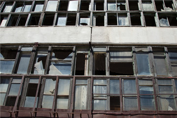 Broken glass in the windows of an abandoned factory