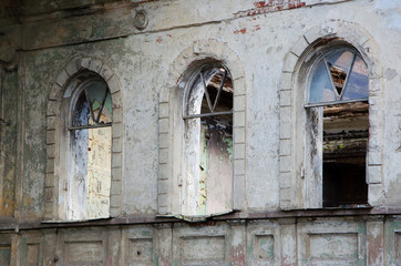 Fototapeta na wymiar Broken windows in a very old ruined building