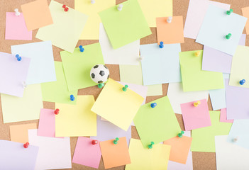 Football or soccer ball and blank sticky notes on notice board in office. Concept image of business related sport and leisure. Reminder of summer vacation and games. - 159158024