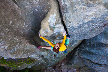 girl climber climbs the rock.