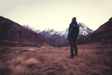 Man standing and looking at view of the mountains