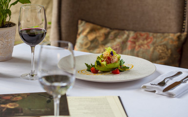 Salad with avocado on the table in the restaurant. Restaurant food concept.