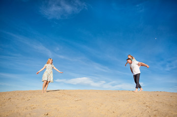 Family playing on the beach, fly, run, laugh at the blue sky background