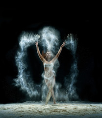 Obraz na płótnie Canvas Pretty girl in cloud of white dust studio portrait