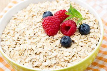 Oatmeal porridge with berries. Raspberries and blueberries.