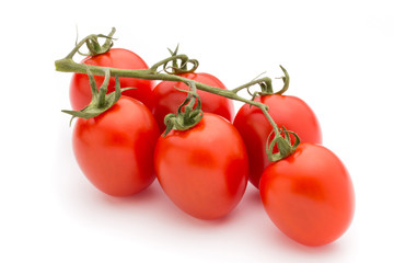 Small plum tomatoes on a white background.