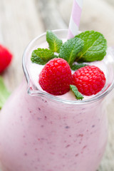Raspberry milk shake with mint decor.