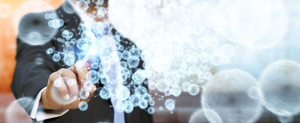 Obraz premium Businessman touching 3D rendering data network sphere with his fingers