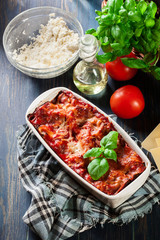 Hot tasty lasagna with spinach in ceramic casserole dish