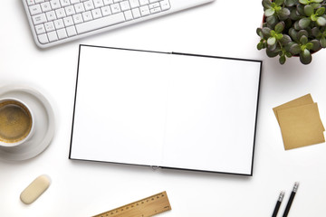 Open Blank Diary Surrounded With Office Supplies And Keyboard