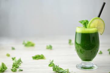 Green smoothies on wooden table