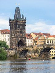 Fototapeta na wymiar prague old town tower at the end of charles bridge and its reflection in vltava river 