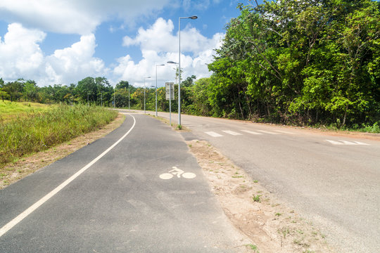 Road with bicycle lane in Saint-Georges town, French Guiana