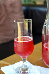 Summer lemonade with raspberry and leaves mint in a glass 