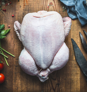 Raw Whole Chicken Or Turkey On Wooden Kitchen Table Background, Top View