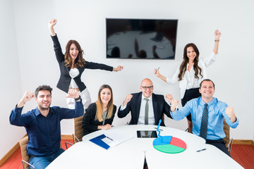 business team celebrating success in office