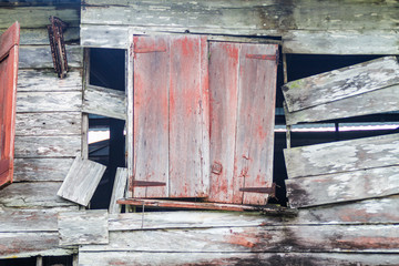 Window of an old wooden house at Peperpot plantation in Suriname