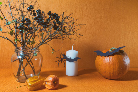 Halloween home decorations on orange background. Still life. Shallow depth of field. Toned.