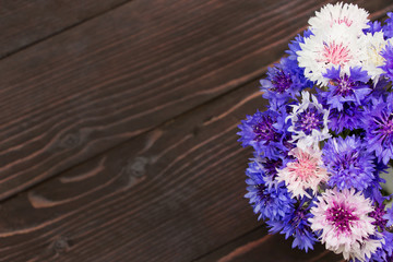 Cornflower(Centaurea)on wooden background