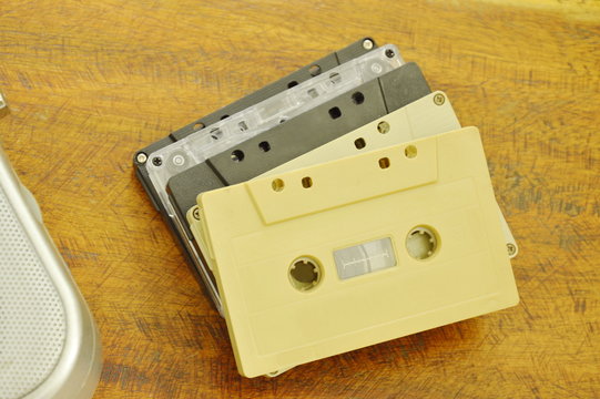 cassette tape recorder and radio loudspeaker on wooden table