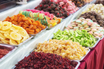 Stand with tasty chewy jelly beans. Colorful street food with sweet tasty delicious candies in...