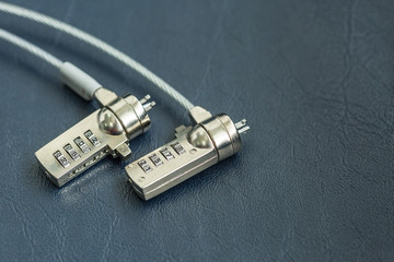 Two computer cable lock on black leather, Security concept shot for the digital age