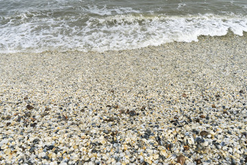 Landscape with sea view, waves and sea shells, clouds, photographed in Gura Portiţei, Romania, in cloudy spring day