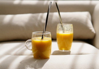 Orange smoothies on a beige background, healthy food
