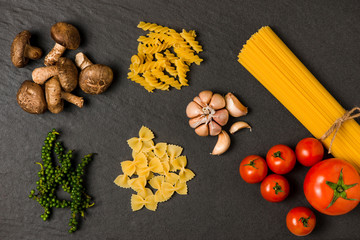 Italian food concept. Pasta ingredients. Cherry-tomatoes, spaghetti pasta, rosemary and spices