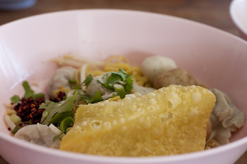 Spicy lemongrass flavored flat noodles with pork